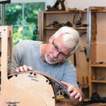 With his specialized tools. Beckwith artfully coaxes wooden sheets into intricate guitar shapes.