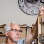 Beckwith prepares the sides of a guitar body in a special press. 