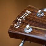 An example of the artisan's craft, a hand cut mother of pearl inlay has been painstakingly inset into the head of a custom guitar. 