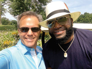 Tom Caron poses for a selfie with Red Sox star David Ortiz at a charity golf tournament.
