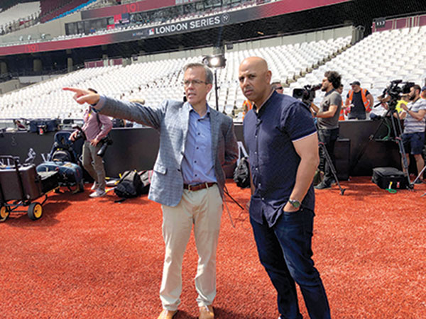Tom Caron poses with Red Sox Manager Alex Cora before the MLB London Series in 2019.