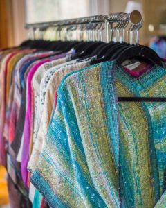 Handwoven Mobius shawls made of rayon boucle, lurex yarn, plus ribbon and supplemental yarns.