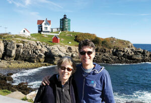 Phil Knutel stands with his birth mother Maggie Byrnes at the Nubble Lighthouse in York, Maine.
