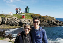 Phil Knutel stands with his birth mother Maggie Byrnes at the Nubble Lighthouse in York, Maine.