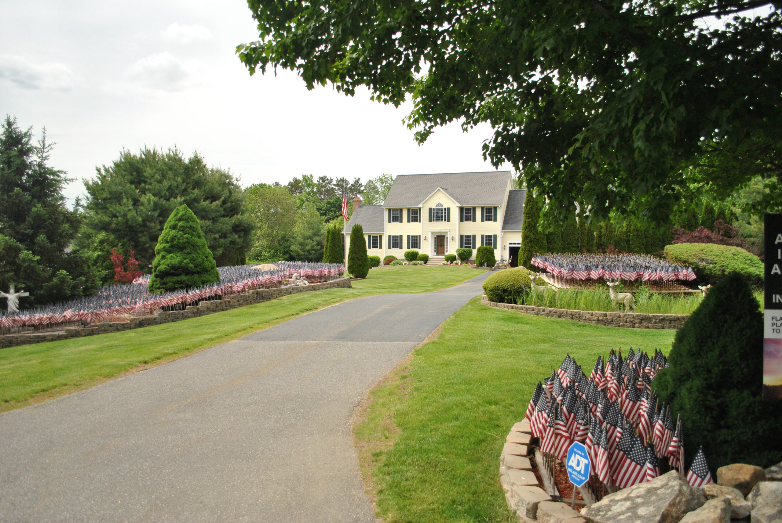 Flags fill the flower beds of Mike Labee’s property in Grafton.