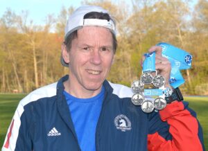 Dan Milton displays his World Marathon Majors medal.