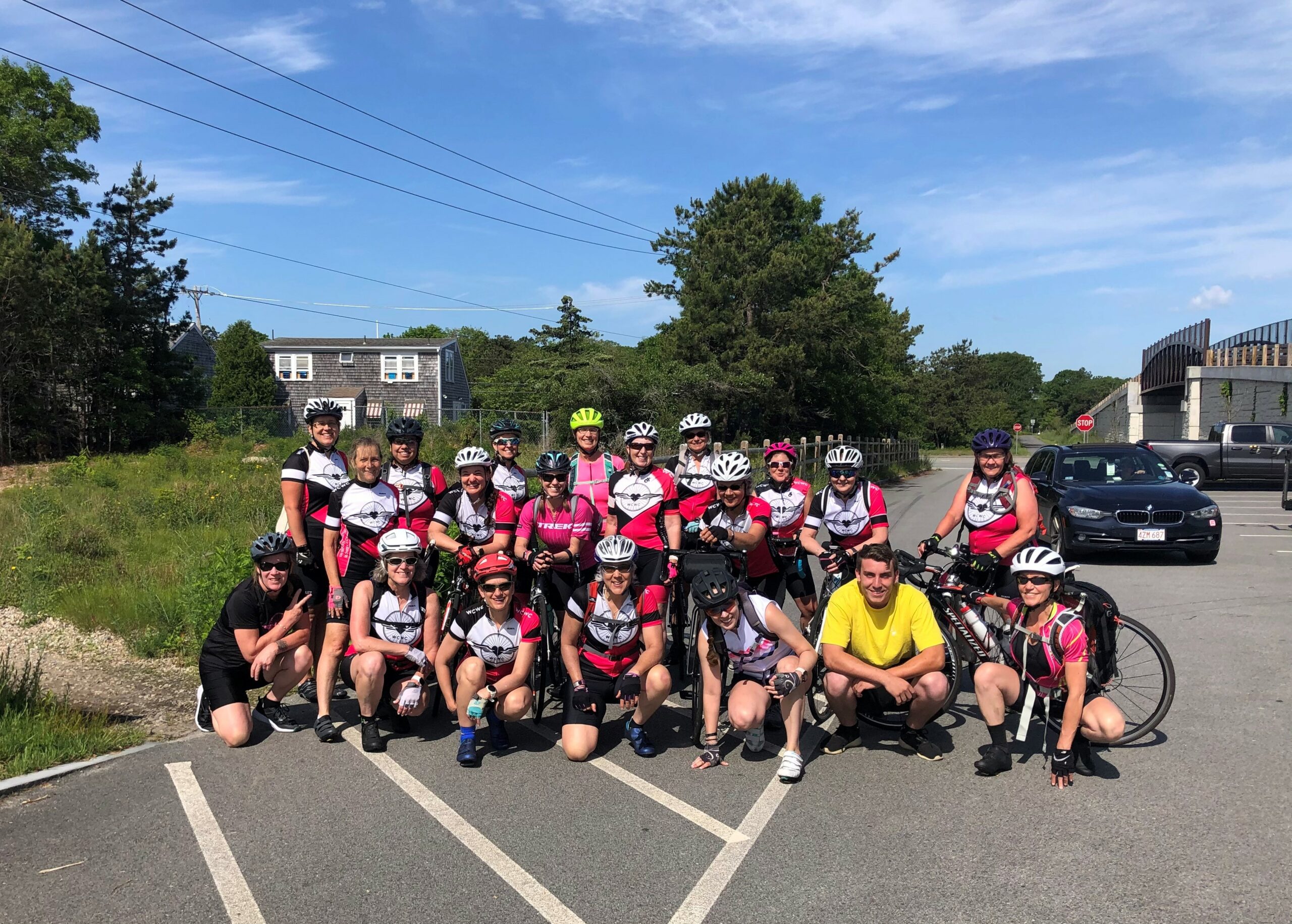 The group grows to 18 for the Wrentham to Provincetown legs of the trek. They pose at a bike path in Yarmouth with Travis Mortell (in yellow shirt), who transported all of the gear.