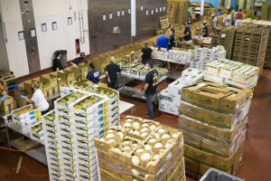 Volunteers sort and pack at Greater Boston Food Bank's central kitchen