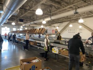 Volunteers at Greater Boston Food Bank practice social distancing