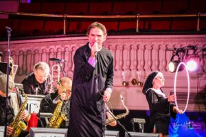 “Fr. Mike Girard” sings with his Big Swinging Thing at Worcester’s Mechanics Hall in 2017. Photo/Mark McCollom