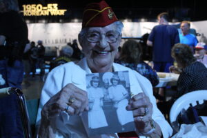 Mildred Cox shows a photo of her and her brother. 