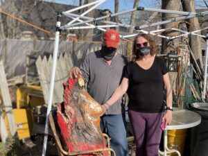 Beth Schrag and Bill Condry stand with what remains of Carl the Cardinal these days.  Photo/Jane Keller Gordon