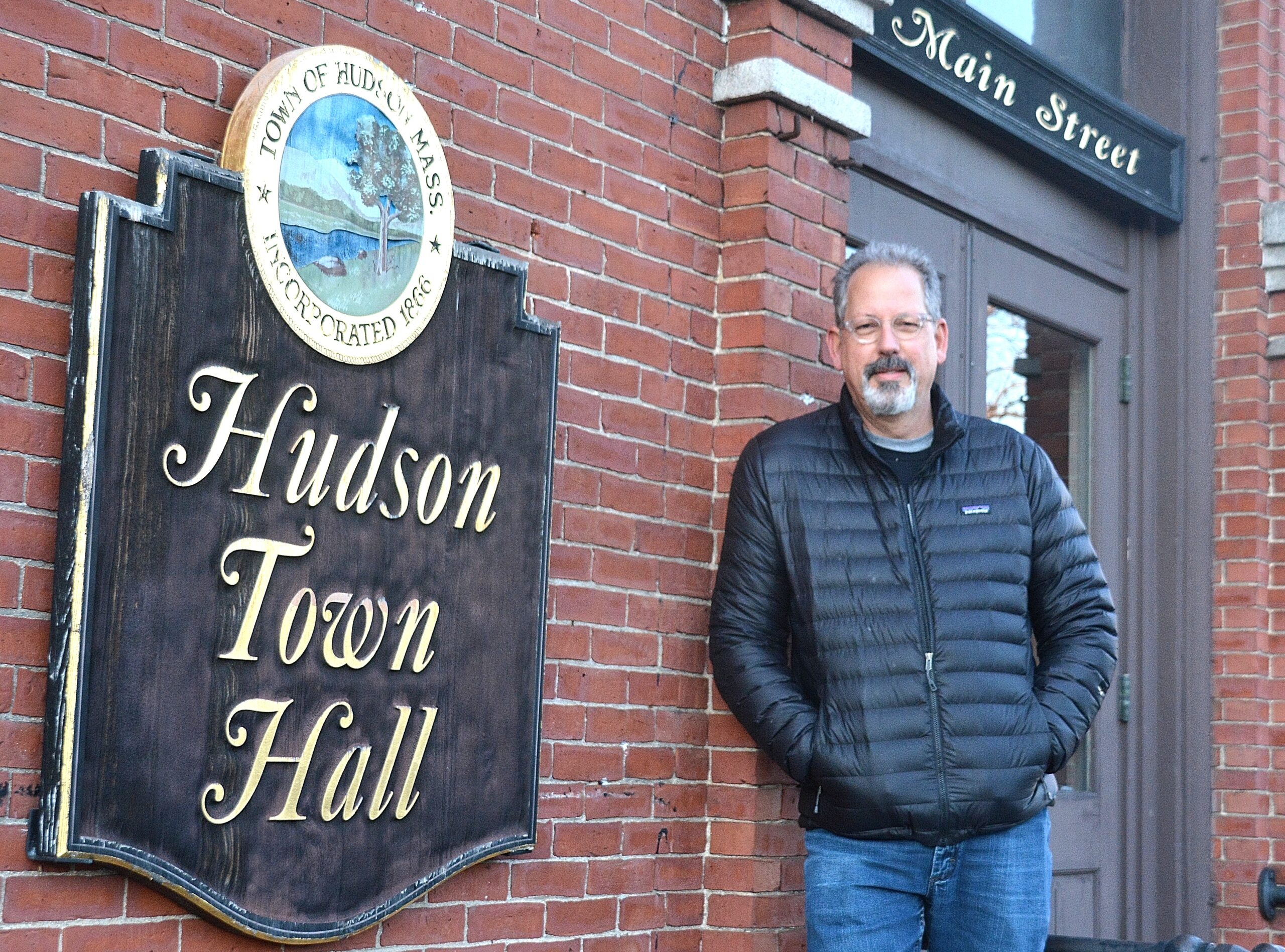 Paul Tucker with his signage at Hudson Town Hall.