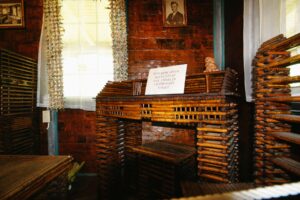 This paper desk features newspaper articles about Charles Lindbergh’s flight across the Atlantic.