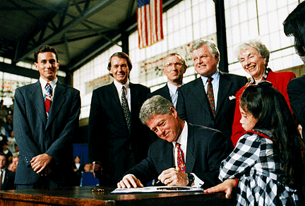 President Bill Clinton signs the sign the Improving America's Schools Act of 1994 on October 20, 1994, inside Framingham High School’s gymnasium.