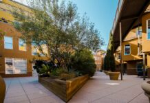 A cohousing development involves a group of individually owned homes, like a condominium, but also includes a common area building where shared meals, meetings, and other events take place.
