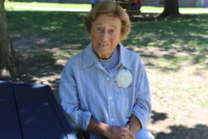 Irma Aronson smiles for a photo at the picnic tables in front of WestboroughHigh School. She recalled the 1953 tornado that had ripped through her home town. 
Photo/Caroline Gordon
