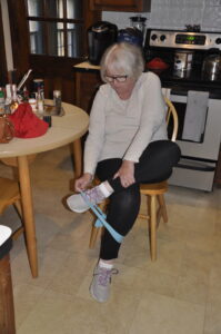 As part of an at-home balance exercise regime, Susan Jarrell of Norwood positions a band around her ankles for a side-step workout to strengthen her leg muscles.Photo/Submitted
