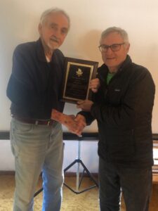 Dennis Pollard, right, of Marlborough, presents a plaque to Davis Cox, of Northborough, to recognize Cox’s six years of service as board chairman of the Massachusetts Senior Games. Pollard is succeeding Cox in that role. (Courtesy photo/Massachusetts Senior Games)


