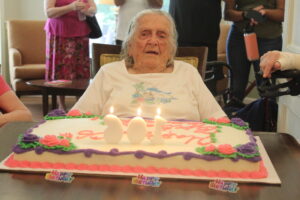 Mildred Wheeler blows out the candles on her birthday cake. She celebrated her 106th birthday in August.