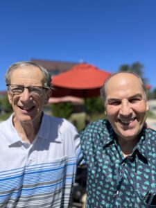 Bill Levine with his friend Lee, to whom he passed on a job opportunity that was a perfect match for him.