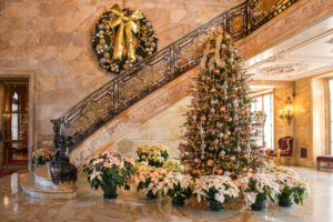  The Marble House foyer welcomes visitors with an ornate Christmas tree and numerous poinsettias.Photo/Courtesy of Newport Mansions
