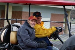 Richard ‘Dick’ Walsh is driven onto the field. Walsh’s championship-winning 1973 squad was ready to meet him on Algonquin’s new turf field. (Photo/Evan Walsh)