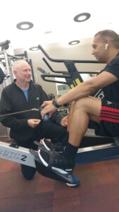 Dr. Bruce Cohen works with one of his fitness clients.