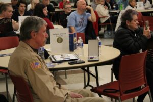 Peter Maybay, left, and Jeanne Wickson, relatives of Michael Blanchette, listen to presentations made during the second annual Medal of Liberty/Medal of Fidelity ceremony on Nov. 9 at the Marlborough Senior Center. Michael Blanchette was killed in Vietnam in 1970; his portrait is on the table.