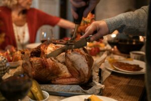 Thanksgiving turkey carving, reflecting Sarah Josepha Hale’s advocacy for the holiday tradition.
