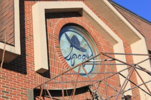 Stained glass window featuring "Spag's" logo, recalling memories of Anthony Borgatti's Shrewsbury store.