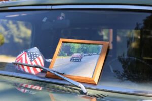Vintage car interior with framed photo of A&M racetrack and drag racing