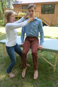 Monica Vegelj demonstrating Alexander Technique posture adjustment with a volunteer.