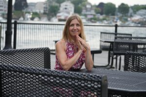 Monica Vegelj, educator and Alexander Technique practitioner, smiling outdoors
