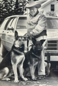Anthony "Spag" Borgatti with German Shepherd dogs and vintage car, Shrewsbury, MA