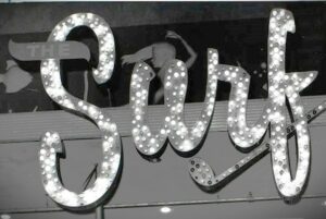 The Surf Ballroom sign illuminated with lights, a historical music venue in Massachusetts.