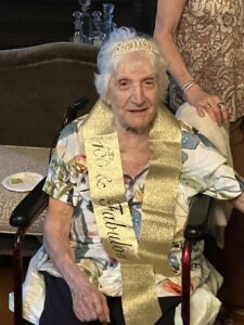 Evelyn Grenier, 100 years old, celebrating with a "100 & Fabulous" sash