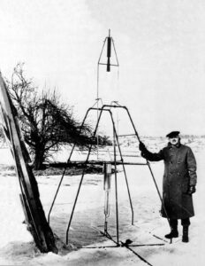 Robert H. Goddard standing beside his early liquid-fueled rocket on Aunt Effie’s farm in Auburn, March 16, 1926, marking the beginning of modern rocketry.