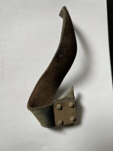 World War II Italian fighter plane remnant and leather seat belt strap