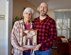 Bonnie and Paul Thiesing, Westborough High School class couple, holding a framed photo from 1979.
