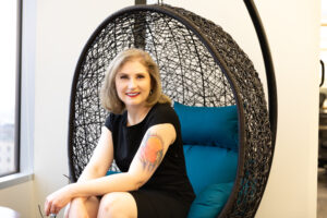 Christina Inge, digital strategist and Thoughtlight founder, seated in a woven chair in Westborough, MA