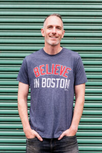Chris Wrenn, Bridge Nine Records founder, wearing "Believe in Boston" shirt