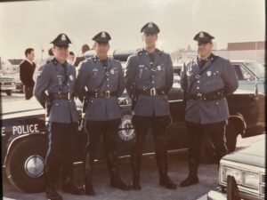 Anthony "Tony" Kurgan Jr. as a Massachusetts State Trooper and colleagues in uniform.