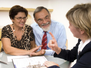 Couple consulting with financial planner about Medicare benefits and fraud prevention.