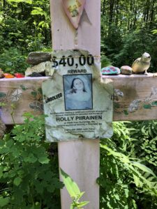 Reward poster for Holly Piirainen, unsolved murder case, memorial in Brimfield woods