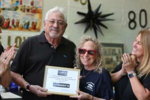 Jon Cohen, owner of Harry’s Restaurant in Westborough, celebrates its 80th anniversary with his staff.