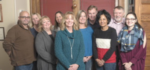 Joanne Peterson, with several of the Learn to Cope team members at their Taunton office.