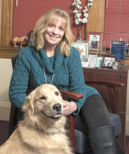 Joanne Peterson, the founder and executive director of Learn to Cope, with team member Kim Leman’s dog, Finn.