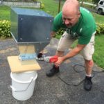 Charlie Herbert sets up his mill on his driveway in Shrewsbury in preparation for mashing grains to use in his next batch of home brew.