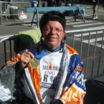 Marty Ayotte displays his medal after completing the 2011 New York Marathon.